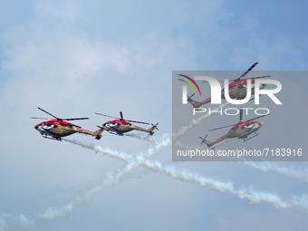 Indian Air Force's Sarang helicopters perform during the full dress rehearsal of Air Force Day parade at the Hindon Air Force Station on the...