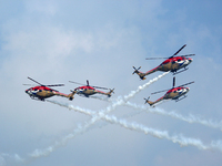 Indian Air Force's Sarang helicopters perform during the full dress rehearsal of Air Force Day parade at the Hindon Air Force Station on the...