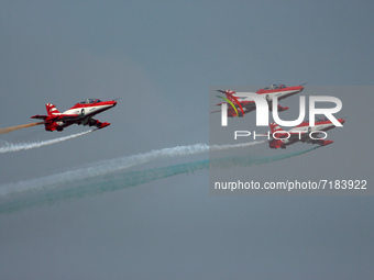 Indian Air Force's acrobatic team 'Surya Kiran' fly in a formation during the full dress rehearsal of Air Force Day parade at the Hindon Air...