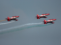 Indian Air Force's acrobatic team 'Surya Kiran' fly in a formation during the full dress rehearsal of Air Force Day parade at the Hindon Air...