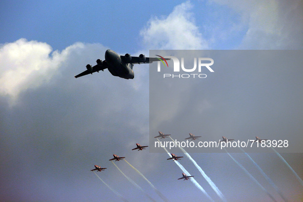 Indian Air Force's C-17 Globemaster (C) along with acrobatic team 'Surya Kiran' fly in a formation during the full dress rehearsal of Air Fo...