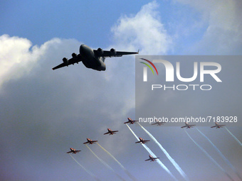 Indian Air Force's C-17 Globemaster (C) along with acrobatic team 'Surya Kiran' fly in a formation during the full dress rehearsal of Air Fo...