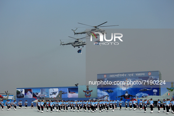 Indian Air Force (IAF) helicopters fly past as soldiers march during Air Force Day parade at the Hindon Air Force Station on the outskirts o...