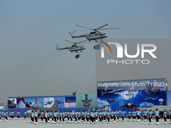 Indian Air Force (IAF) helicopters fly past as soldiers march during Air Force Day parade at the Hindon Air Force Station on the outskirts o...