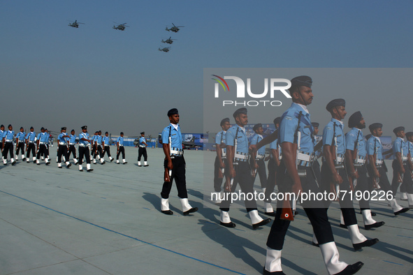 Indian Air Force (IAF) helicopters fly past as soldiers march during Air Force Day parade at the Hindon Air Force Station on the outskirts o...