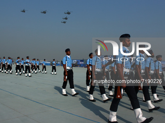 Indian Air Force (IAF) helicopters fly past as soldiers march during Air Force Day parade at the Hindon Air Force Station on the outskirts o...