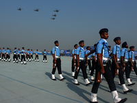 Indian Air Force (IAF) helicopters fly past as soldiers march during Air Force Day parade at the Hindon Air Force Station on the outskirts o...