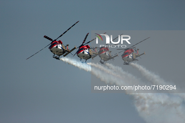 Indian Air Force's (IAF) Sarang helicopters perform during the 89th Air Force Day parade at Hindon Air Force Station on the outskirts of New...