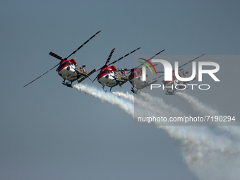 Indian Air Force's (IAF) Sarang helicopters perform during the 89th Air Force Day parade at Hindon Air Force Station on the outskirts of New...