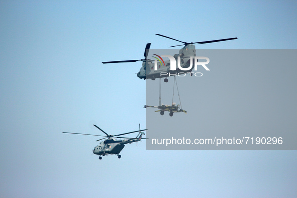 Indian Air Force's (IAF) Chinook helicopter fly past carrying artillery gun along with an Mi-17V-5 helicopter during the 89th Air Force Day...