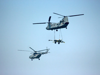 Indian Air Force's (IAF) Chinook helicopter fly past carrying artillery gun along with an Mi-17V-5 helicopter during the 89th Air Force Day...