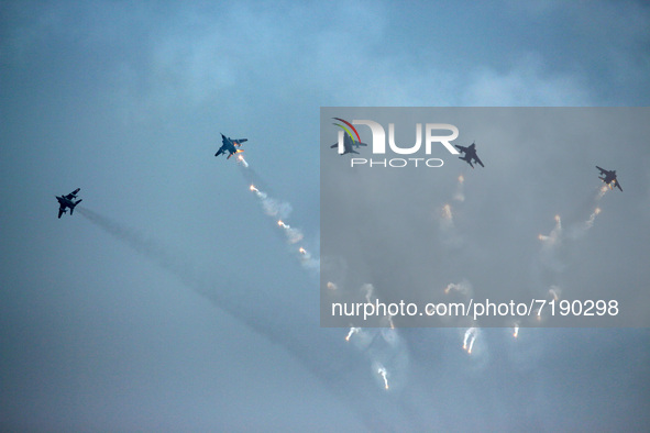 Indian Air Force's (IAF) Jaguar aircrafts fire flares as they fly past during the 89th Air Force Day parade at Hindon Air Force Station on t...