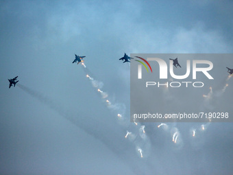 Indian Air Force's (IAF) Jaguar aircrafts fire flares as they fly past during the 89th Air Force Day parade at Hindon Air Force Station on t...