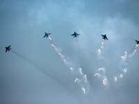 Indian Air Force's (IAF) Jaguar aircrafts fire flares as they fly past during the 89th Air Force Day parade at Hindon Air Force Station on t...