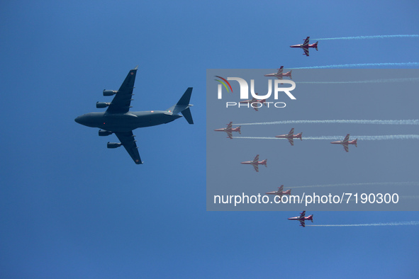 Indian Air Force's (IAF) C-17 Globemaster leads as acrobatic team 'Surya Kiran' fly in a formation during the 89th Air Force Day parade at H...