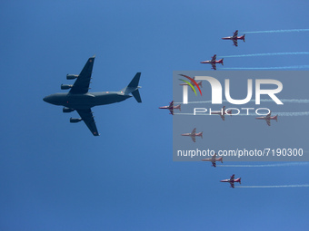 Indian Air Force's (IAF) C-17 Globemaster leads as acrobatic team 'Surya Kiran' fly in a formation during the 89th Air Force Day parade at H...