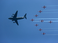 Indian Air Force's (IAF) C-17 Globemaster leads as acrobatic team 'Surya Kiran' fly in a formation during the 89th Air Force Day parade at H...