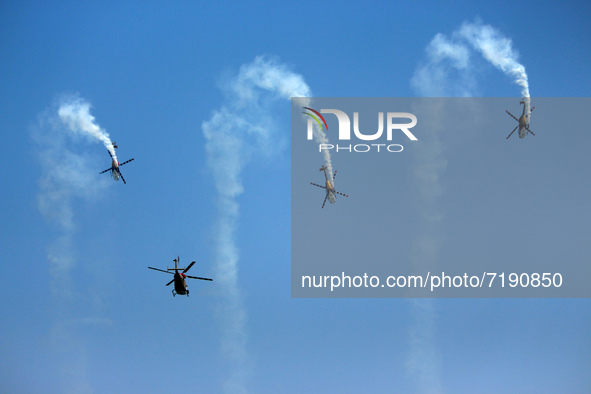 Indian Air Force's (IAF) Sarang helicopters perform aerobatic maneuvers during the 89th Air Force Day parade at Hindon Air Force Station on...