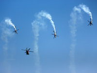 Indian Air Force's (IAF) Sarang helicopters perform aerobatic maneuvers during the 89th Air Force Day parade at Hindon Air Force Station on...