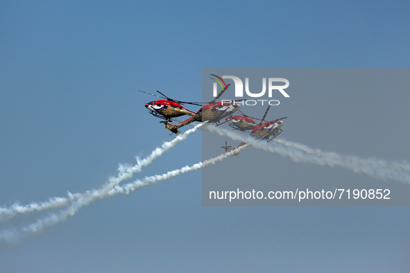 Indian Air Force's (IAF) Sarang helicopters perform aerobatic maneuvers during the 89th Air Force Day parade at Hindon Air Force Station on...