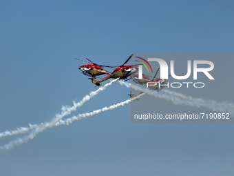 Indian Air Force's (IAF) Sarang helicopters perform aerobatic maneuvers during the 89th Air Force Day parade at Hindon Air Force Station on...