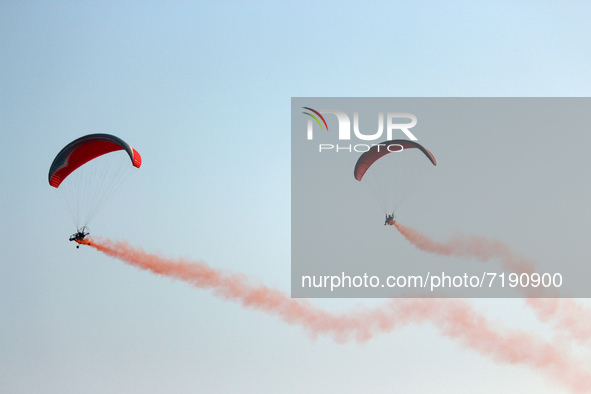 Indian Air Force's (IAF) para motor gliders perform in the air during the 89th Air Force Day parade at Hindon Air Force Station on the outsk...