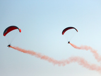 Indian Air Force's (IAF) para motor gliders perform in the air during the 89th Air Force Day parade at Hindon Air Force Station on the outsk...