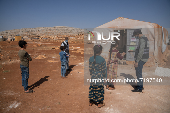 Children attend the first day of school in a refugees camp in the countryside of Idlib. on October 9, 2021. 