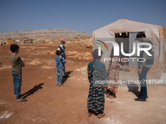 Children attend the first day of school in a refugees camp in the countryside of Idlib. on October 9, 2021. (