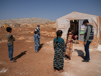 Children attend the first day of school in a refugees camp in the countryside of Idlib. on October 9, 2021. (