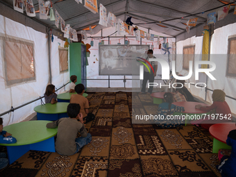 Children attend the first day of school in a refugees camp in the countryside of Idlib. on October 9, 2021. (