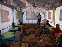 Children attend the first day of school in a refugees camp in the countryside of Idlib. on October 9, 2021. (