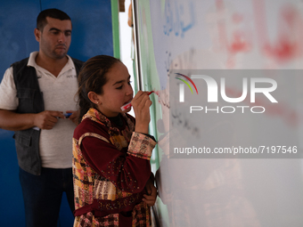 Children attend the first day of school in a refugees camp in the countryside of Idlib. on October 9, 2021. (