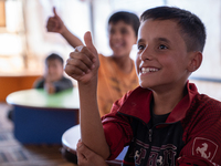 Children attend the first day of school in a refugees camp in the countryside of Idlib. on October 9, 2021. (