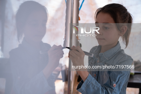 Children attend the first day of school in a refugees camp in the countryside of Idlib. on October 9, 2021. 