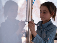 Children attend the first day of school in a refugees camp in the countryside of Idlib. on October 9, 2021. (