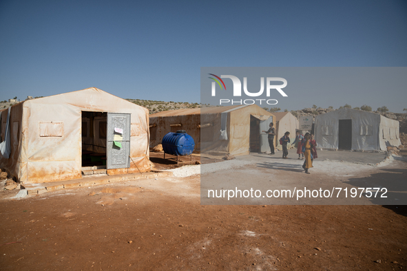 Children attend the first day of school in a refugees camp in the countryside of Idlib. on October 9, 2021. 