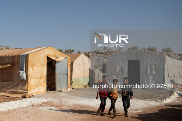 Children attend the first day of school in a refugees camp in the countryside of Idlib. on October 9, 2021. 