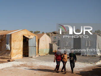 Children attend the first day of school in a refugees camp in the countryside of Idlib. on October 9, 2021. (