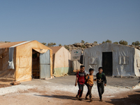 Children attend the first day of school in a refugees camp in the countryside of Idlib. on October 9, 2021. (