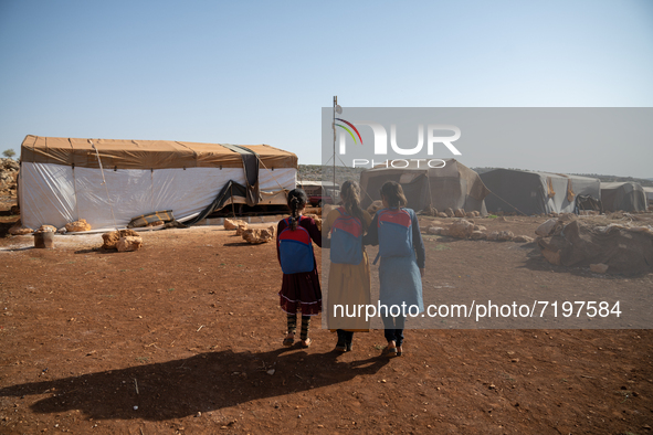 Children attend the first day of school in a refugees camp in the countryside of Idlib. on October 9, 2021. 