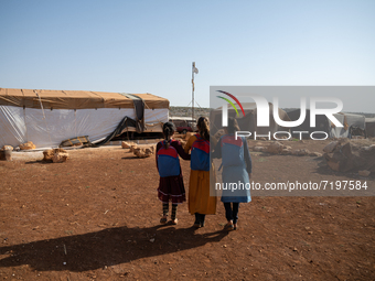 Children attend the first day of school in a refugees camp in the countryside of Idlib. on October 9, 2021. (