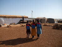 Children attend the first day of school in a refugees camp in the countryside of Idlib. on October 9, 2021. (