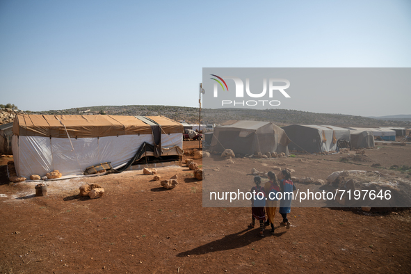 Children attend the first day of school in a refugees camp in the countryside of Idlib on October 9, 2021. 