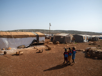 Children attend the first day of school in a refugees camp in the countryside of Idlib on October 9, 2021. (