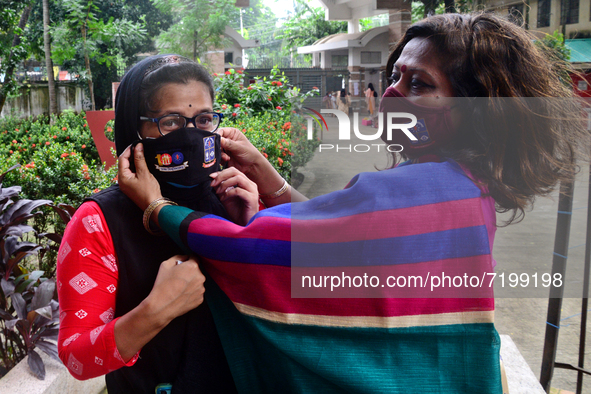 A hall provost wearing face mask a students during entry at the residential hall at Dhaka University after reopen their residential halls af...