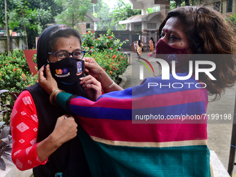 A hall provost wearing face mask a students during entry at the residential hall at Dhaka University after reopen their residential halls af...