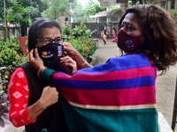 A hall provost wearing face mask a students during entry at the residential hall at Dhaka University after reopen their residential halls af...