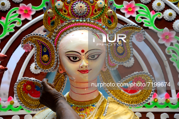 An artist gives final touch to the idol of Hindu Goddess Durga during Durga puja festival in Dhaka, Bangladesh, on October 10, 2021 