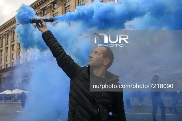 Veterans of Russian-Ukrainian war , activists and supporters of Ukraine's nationalist movements,  burn smoke grenades during a procession to...